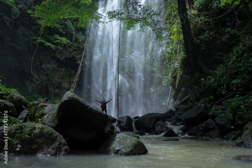 A man explores the tropical rainforests to find a hidden waterfall