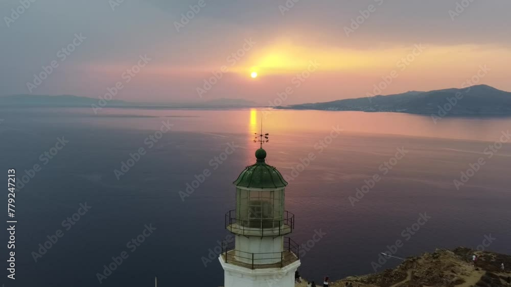 Aerial video of the Armenianstis lighthouse on the seashore at a spectacular sunset in Mykonos Aerial video of the Armenianstis lighthouse on the seashore at a spectacular sunset in Mykonos