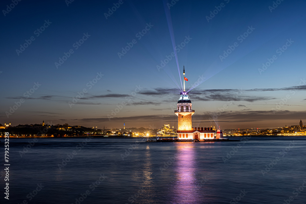 iery sunset over Bosphorus with famous Maiden's Tower (Kiz Kulesi) also known as Leander's Tower, symbol of Istanbul, Turkey. Scenic travel background for wallpaper or guide book