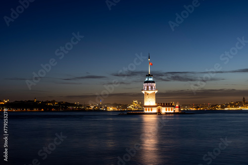 iery sunset over Bosphorus with famous Maiden's Tower (Kiz Kulesi) also known as Leander's Tower, symbol of Istanbul, Turkey. Scenic travel background for wallpaper or guide book photo