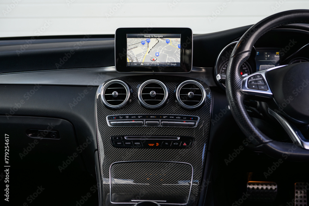 Fototapeta premium Close-Up of Car Dashboard Design and Controls with Carbon Fibre and Navigation