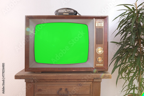 green screen, old retro analog TV 1960-1970, rotary dial telephone, blank screen for designer, background, stylish mockup, template for video
