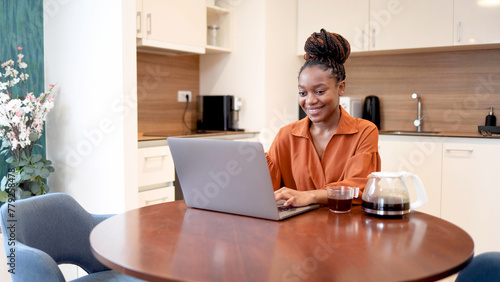 Happy African woman working online