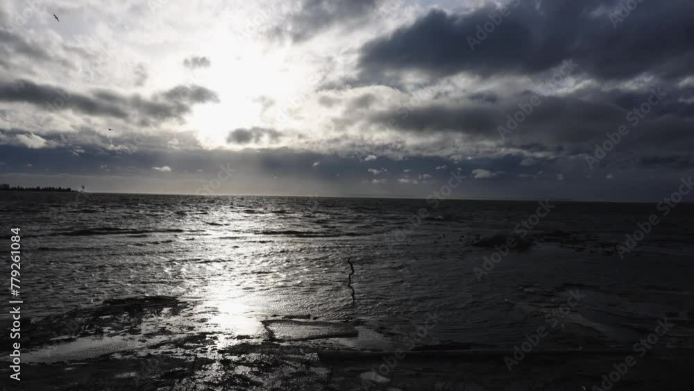 Dramatic Ocean Sunset with Sun Rays Through Clouds Dramatic Ocean Sunset with Sun Rays Through Clouds