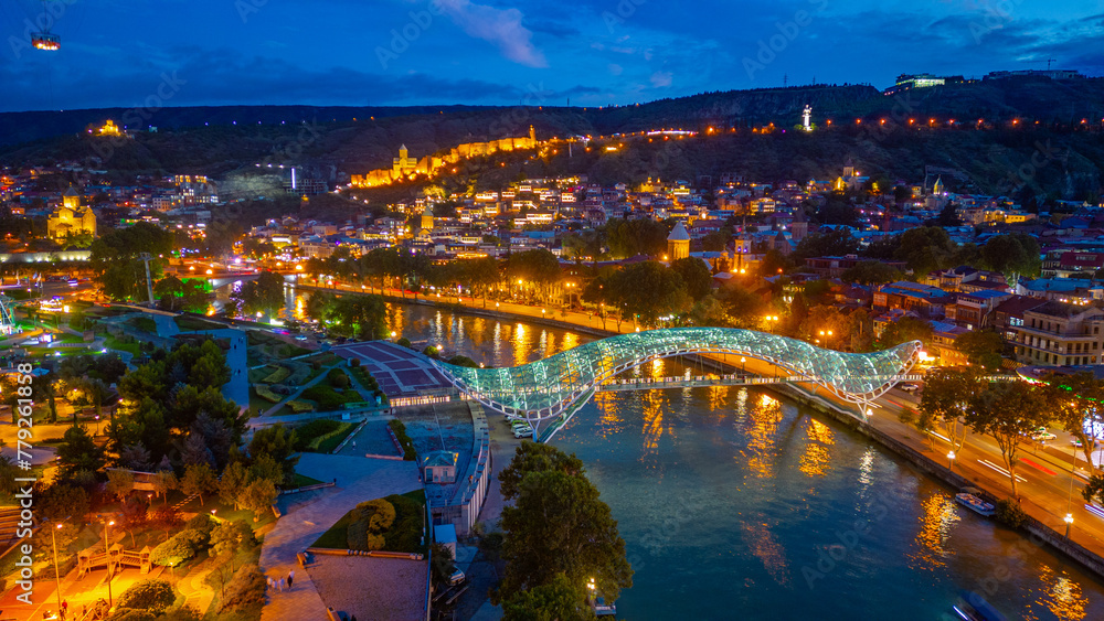 Fototapeta premium Sunset view of Narikala fortress and the Bridge of Peace in Tbilisi, Georgia