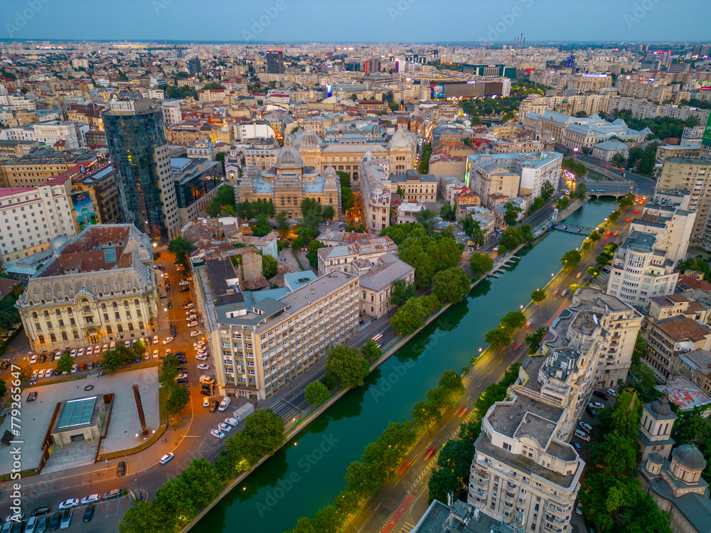 Fototapeta premium Sunset panorama view of Dambovita river passing the old town of Bucharest, Romania