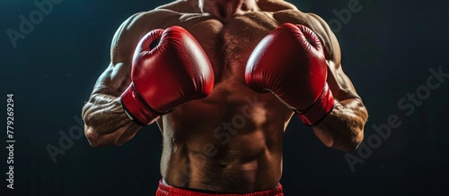 A focused image featuring a man wearing boxing gloves, striking a pose for a photograph.