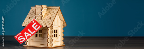 Decorative wooden house decorated with red  Sale  ribbon