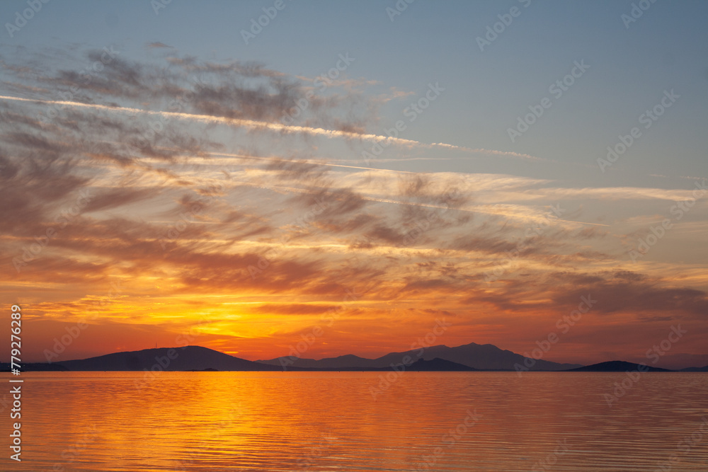 Sunset over Lake with mountains in the background. Beautiful sunset over lake. Sunset over Lake with mountains in the background. Beautiful sunset over lake.