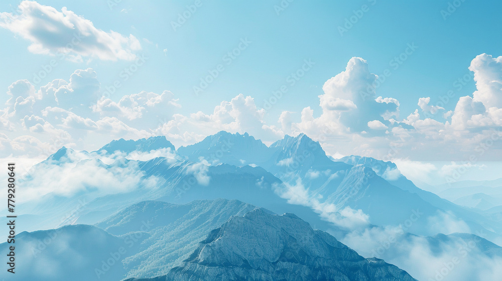 A breathtaking mountain range against a clear blue sky with fluffy white clouds.