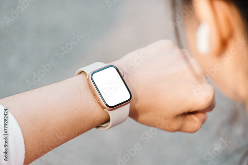 Close-up of a person wrist wearing a modern smartwatch with a blank screen, indicating connectivity and technology in everyday life.