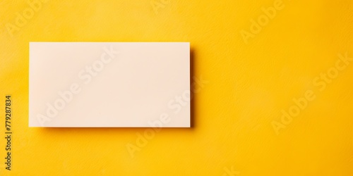 Yellow blank business card template empty mock-up at yellow textured background with copy space for text photo or product