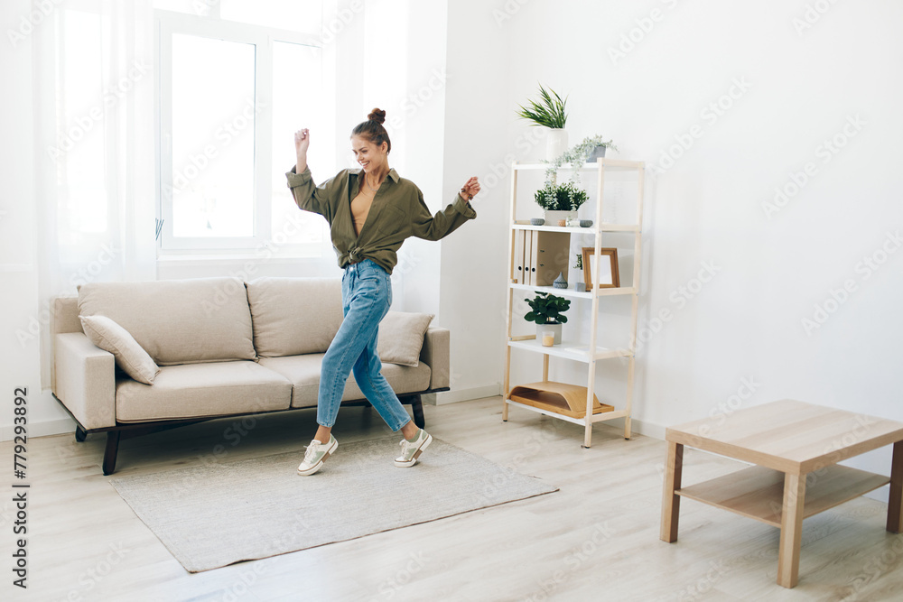 Playful Joy: A Happy Woman Jumping and Dancing in her Home Interior Playful Joy: A Happy Woman Jumping and Dancing in her Home Interior