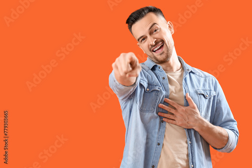 Laughing young man pointing...