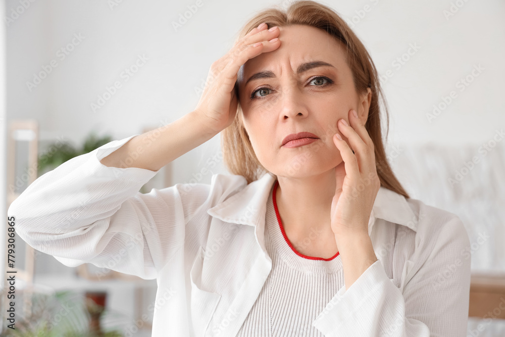 Upset mature woman experiencing menopause at home, closeup Upset mature woman experiencing menopause at home, closeup