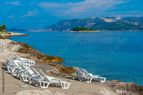 Sun loungers at a beach in Cavtat, Croatia photo