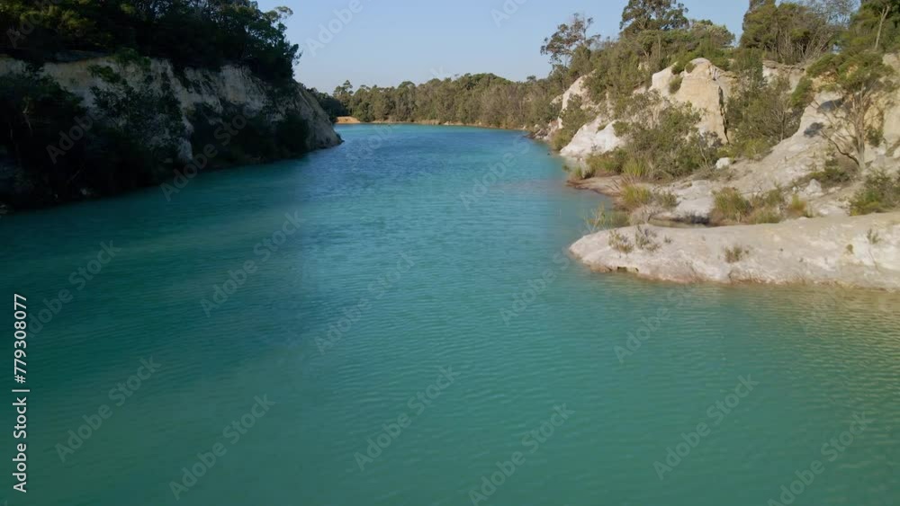 Aerial profile view of clear water of little blue lake in Tasmania, Australia during daytime. Aerial profile view of clear water of little blue lake in Tasmania, Australia during daytime.