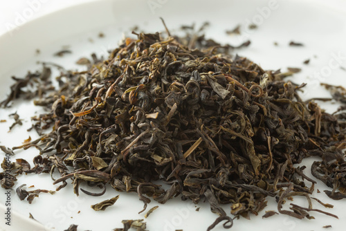 A closeup view of a pile of loose leaf bi luo chun green tea. photo