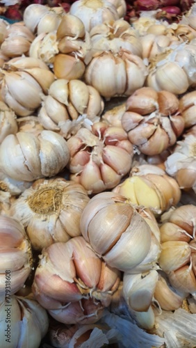 Close up pile of fresh garlic placed together in local market as a background