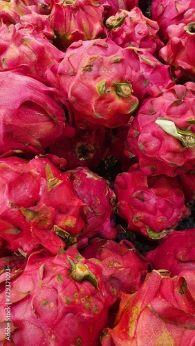 Close up pile of tasty fresh dragon fruit sold at the market as a background.	
