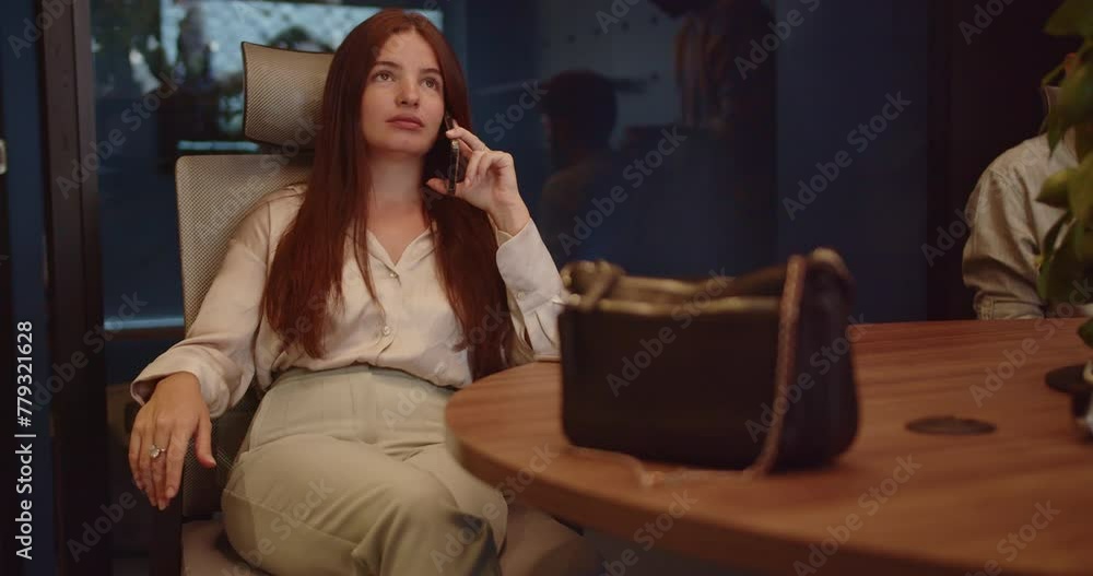 Young female broker having phone call with client, buying or selling, working at small modern office. Young female broker having phone call with client, buying or selling, working at small modern office.