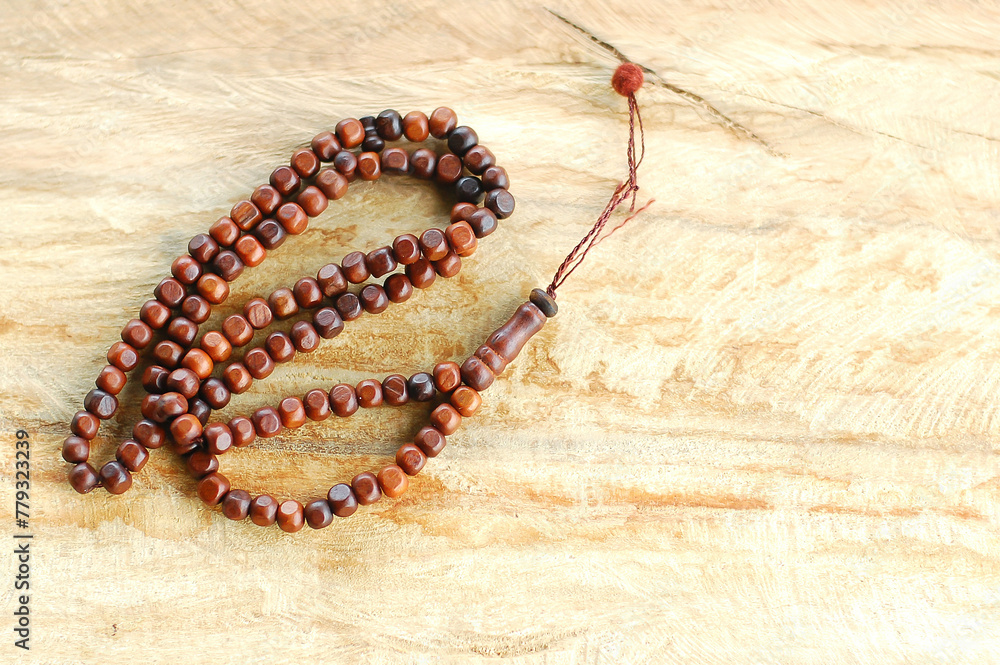 Muslim prayer rosary beads isolated on wooden background. Muslim prayer rosary beads isolated on wooden background.