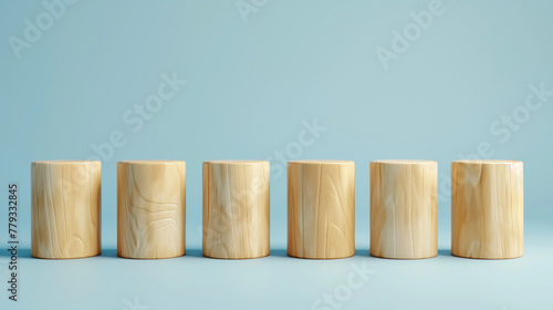 modern minimalist wallpaper wood cylinders in a row on plain blue background, business background or website homepage banner 