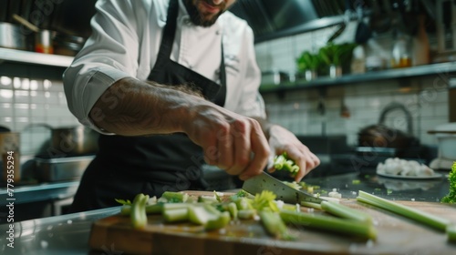 Chef precisely chopping vegetables in commercial kitchen.