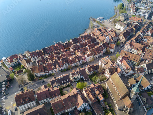 Aerial drone image of the old town of Zug at the waterfront of Lake Zug, Switzerland
