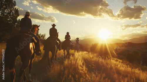 a group of people riding horses into the sunset