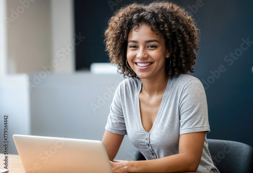 Cheerful Woman Using Laptop in Cafe