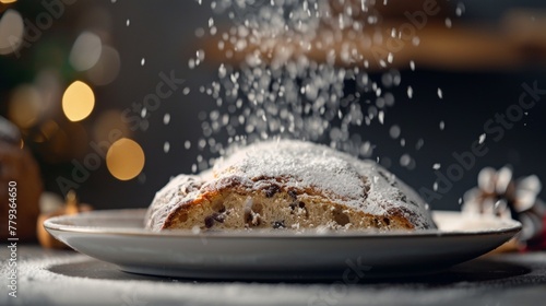 A white plate holding a stollen cake covered in powdered sugar photo