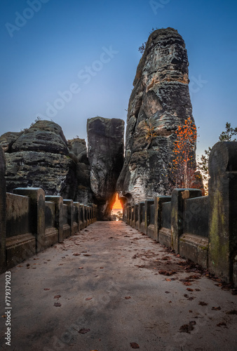 Saxon, Germany - The Bastei bridge on a sunny sunrise with colorful clear blue sky, autumn foliage and rock formations. Bastei is famous for the beautiful rock formation in Saxon Switzerland National