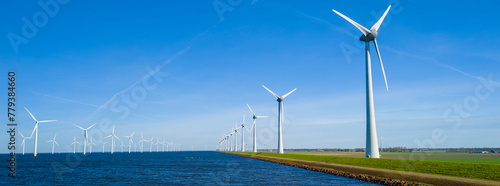 A serene scene in the Netherlands Flevoland, with a picturesque row of wind turbines in Spring photo