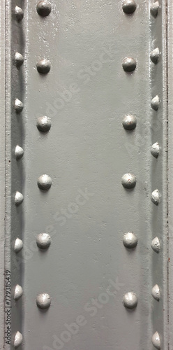 grey wall with round head rivet bolts