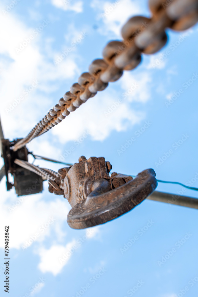 Old rusty metal chain hanging, Rusty chain links outdoors in close up, detail of a chain and hook of a lifting winch Old rusty metal chain hanging, Rusty chain links outdoors in close up, detail of a chain and hook of a lifting winch