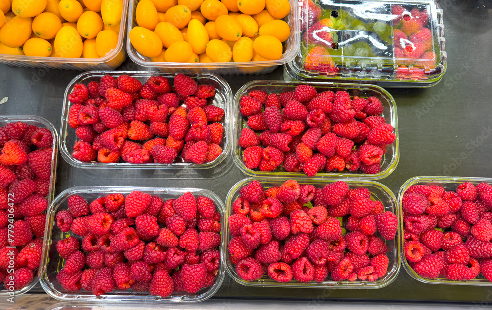 Fresh raspberries on the counter in the market Fresh raspberries on the counter in the market