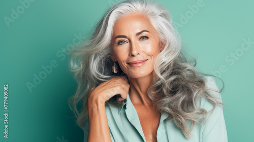 Elegant, elderly, chic latino, Spain woman with gray long hair and perfect skin, green background, banner. photo
