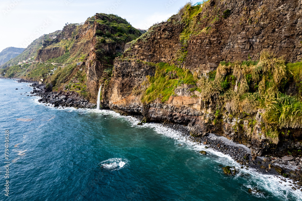 Waterfall fall into Atlantic Ocean in Madeira Island, Portugal. Aerial Drone view