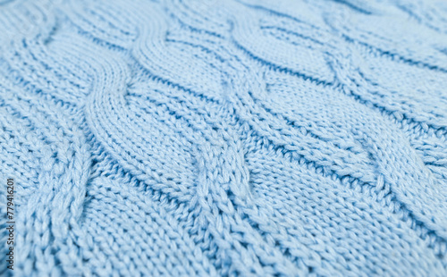 Blue knitted fabric background. Knitted braids texture. 