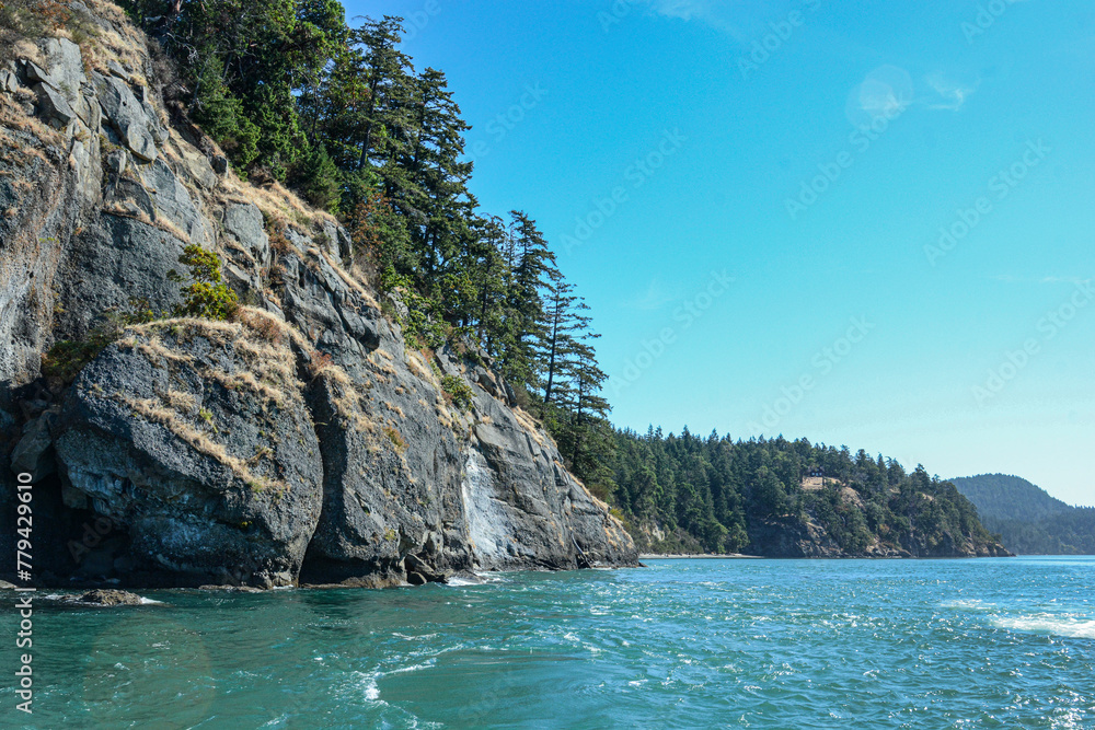 Scenic cliffs along the blue waters of Victoria, BC, Canada