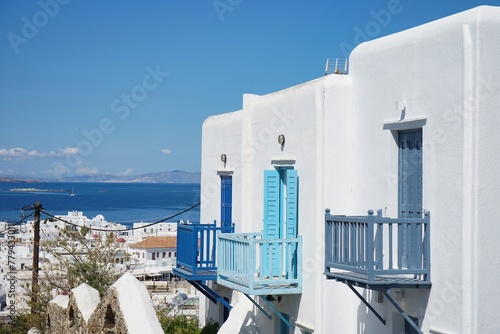 Homes of Mykonos with bright blue balconies overlooking the Old Town and Aegean Sea in Mykonos, Greece