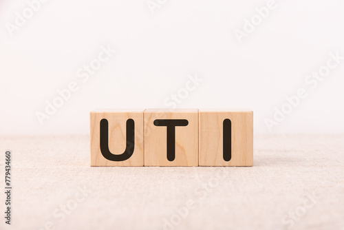 UTI - acronym from wooden blocks with letters, abbreviation UTI urinary tract infection.