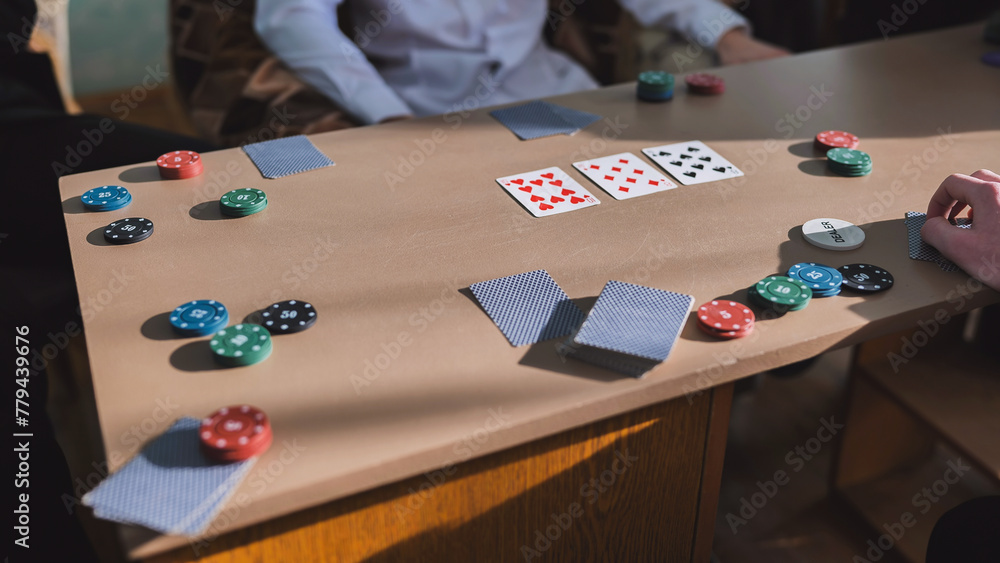 Obraz premium High school students play poker in their free time.