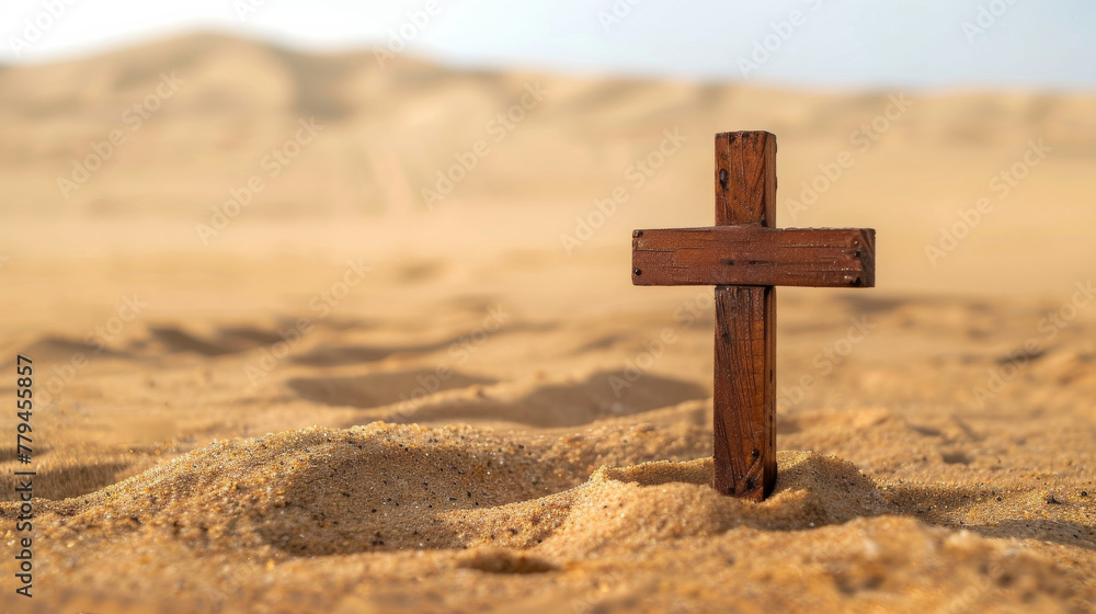 Small wooden Christian cross in middle of sand and sand summer desert in background and copy space
