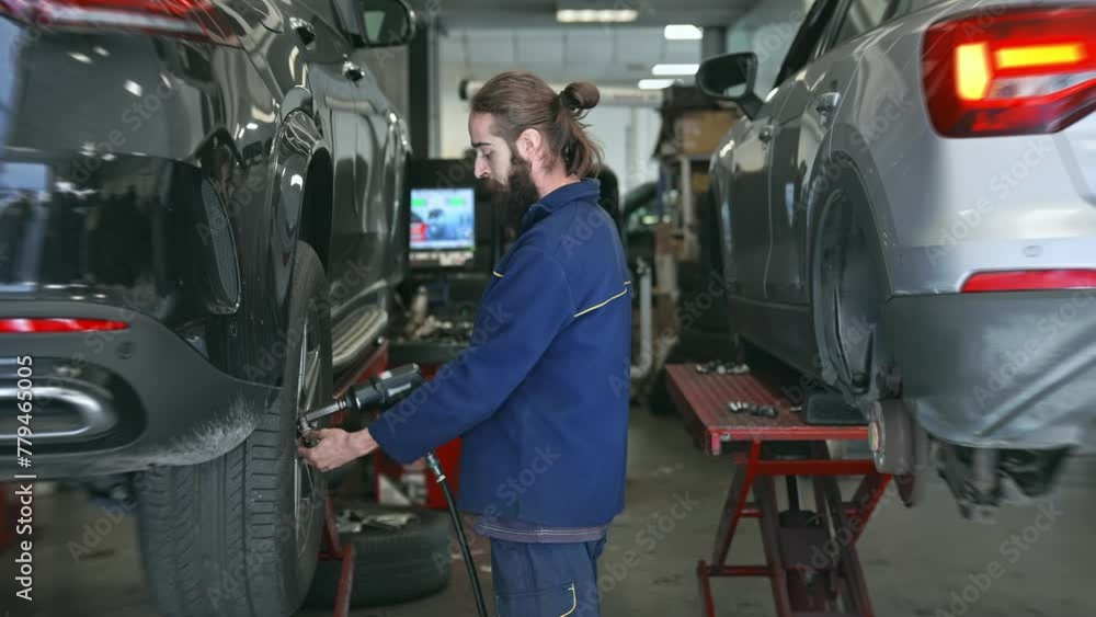 Technician work car service. Auto mechanic portrait. Cute smile engineer look camera. 30s man change tyre cover. Guy fix big wheel tire workshop. Happy worker repair cast disk. Repairman hold pistol. Technician work car service. Auto mechanic portrait. Cute smile engineer look camera. 30s man change tyre cover. Guy fix big wheel tire workshop. Happy worker repair cast disk. Repairman hold pistol.