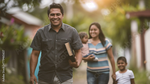 Happy man walks with Bible book under his arm with family