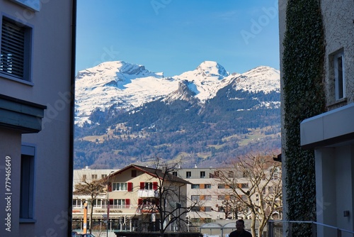 Stunning view of the alps peaking through the buildings of Vaduz, Liechtenstein