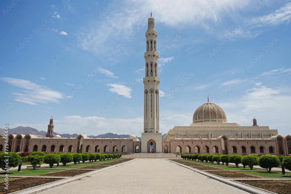 Landscape shot of the vast gardens and complex of the Sultan Qaboos Grand Mosque on a sunny day during Ramadan in Muscat, Oman