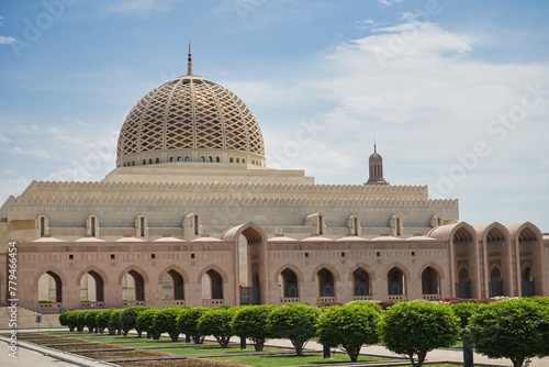 Central dome and gardens of the lavish Sultan Qaboos Grand Mosque on a sunny Ramadan day in Muscat, Oman